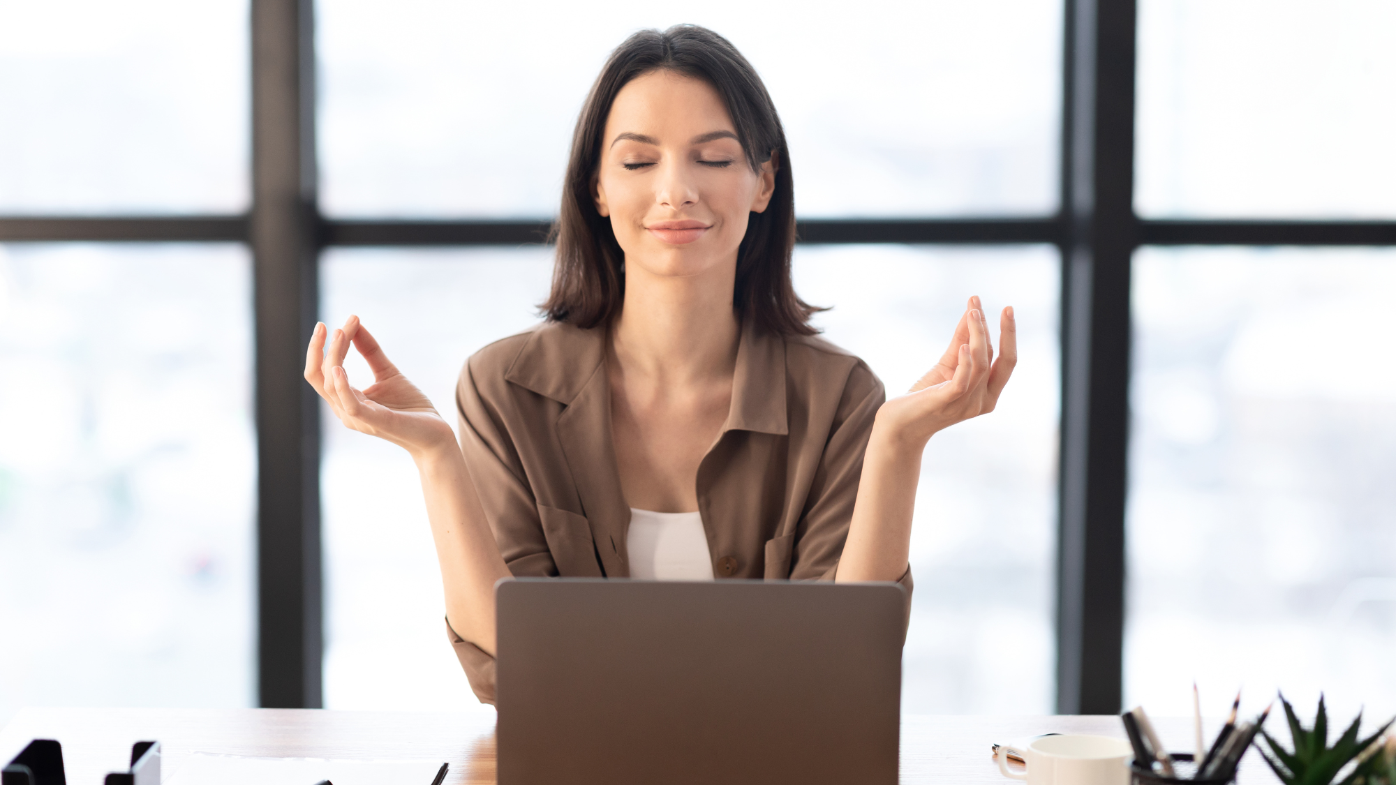 Girl meditating in office coping with stress at work
