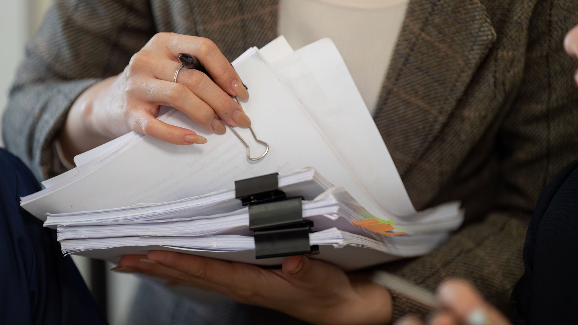 Organization and Documentation. A woman managing a stack of documents, ensuring effective organization and clarity