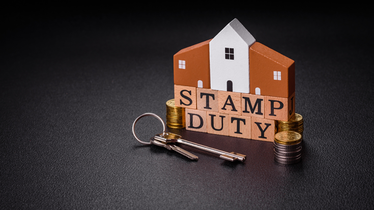 The inscription Stamp Duty made of wooden cubes on a plain background