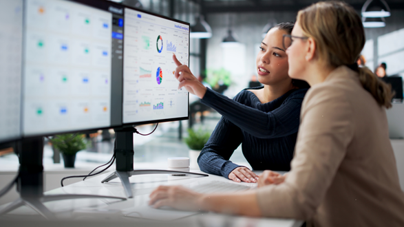 Two women checking the data on computer