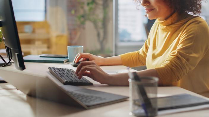 Woman checking on laptop how to safely develop your business abroad