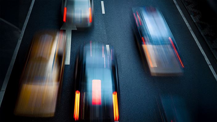 Blurred cars on dark road