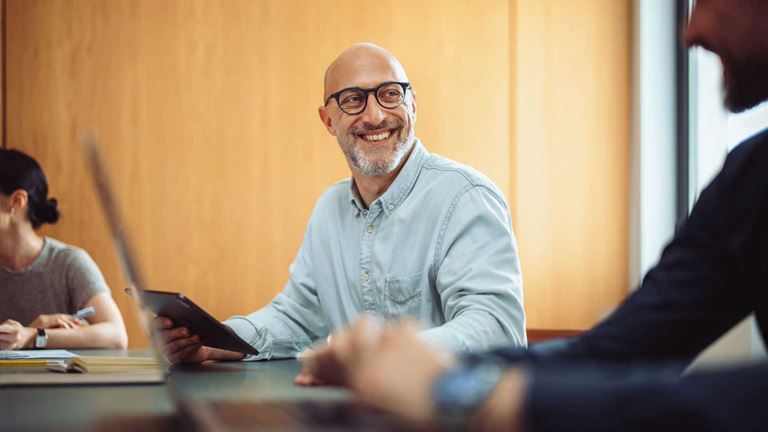 A businessman smiling in a meeting