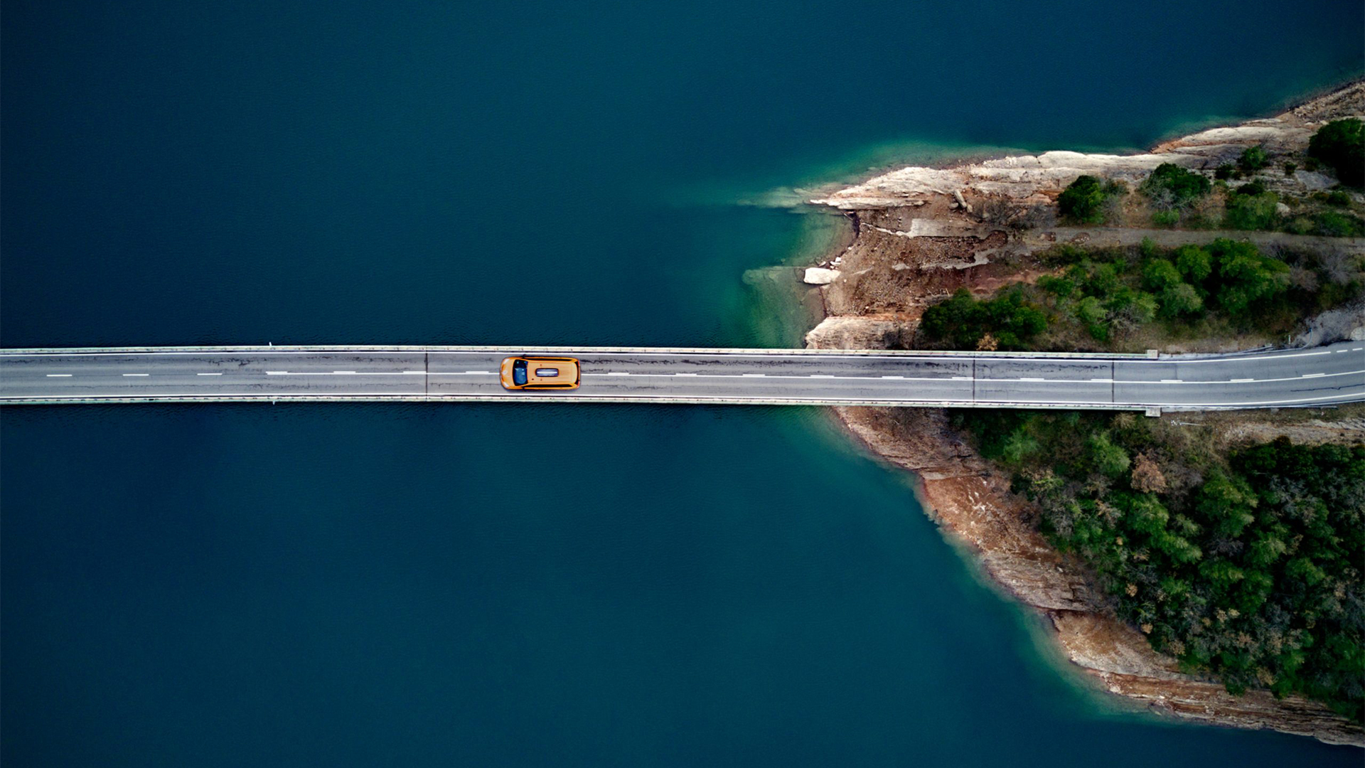 Car on road over water