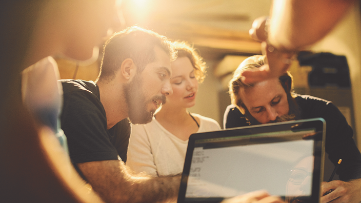People around a laptop