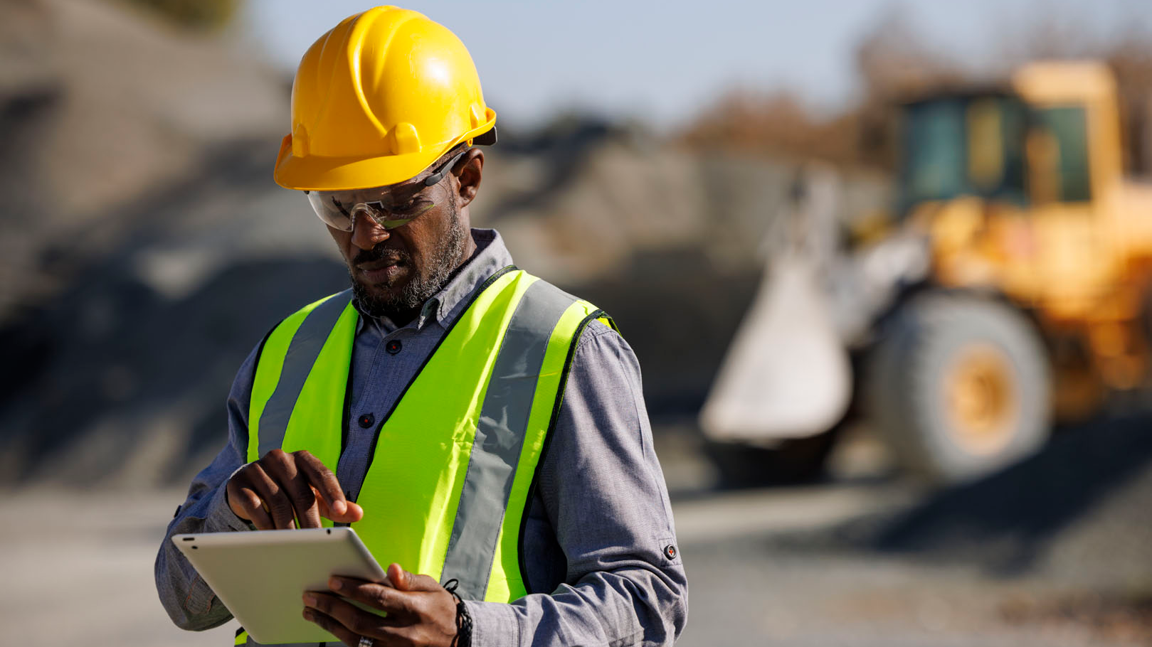 engineer in construction hat and safety vest on site