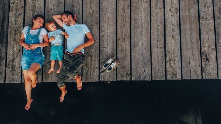 family laying on jetty
