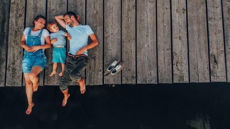family laying on jetty
