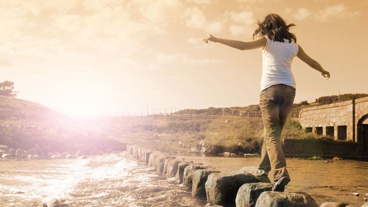 girl walking rocks