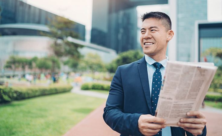 Man holding papers smiling