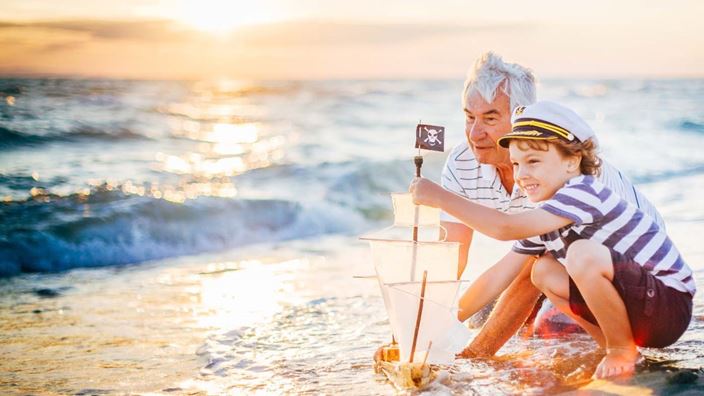 Grandparent and grandchild beach