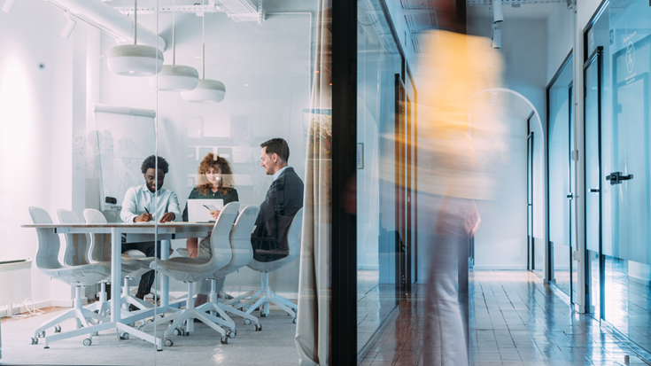 group of people meeting in a glass office