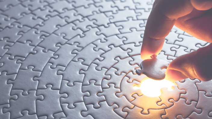 hand placing puzzle