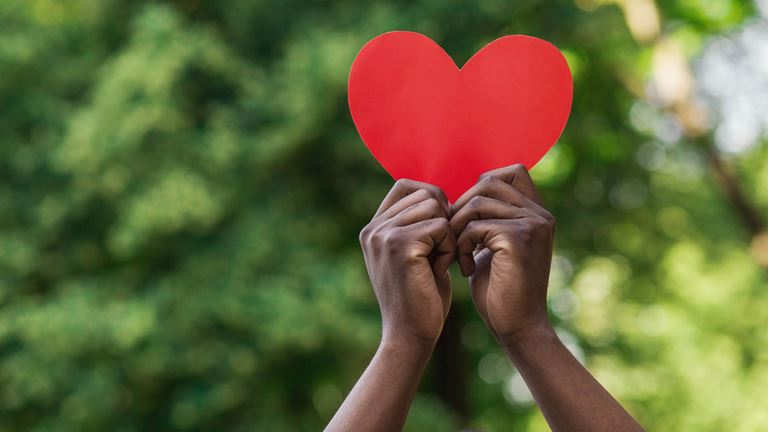 holding red heart with two hands