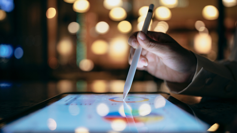 ipad and pen with graphs