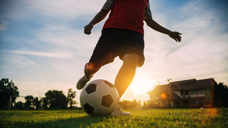 kicking a football