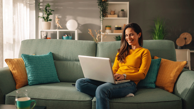 Lady-sitting-on-sofa-with-laptop