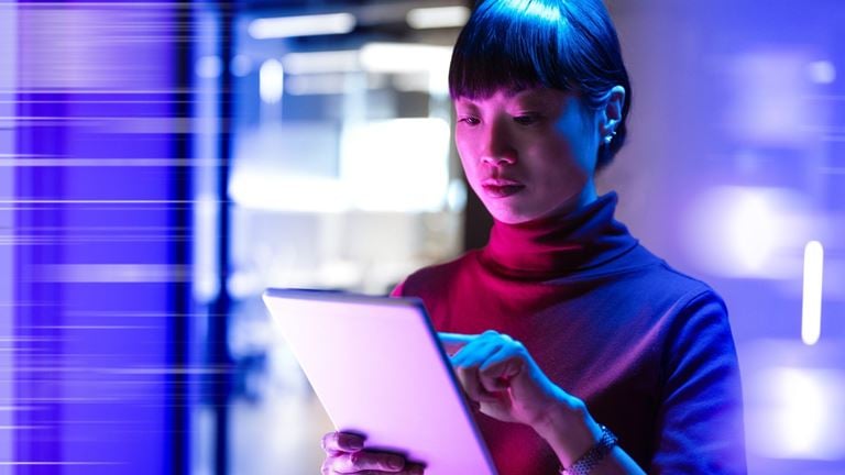 lady with ipad in neon office