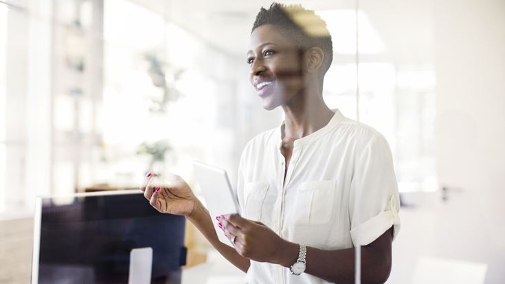 lady with phone and computer nearby