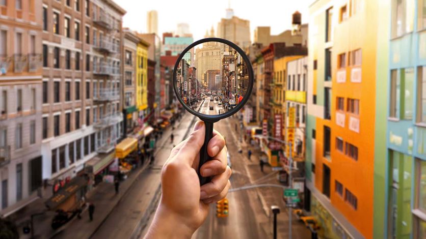 Magnifying glass on city road centred image