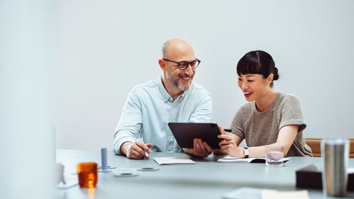 man and woman on an ipad