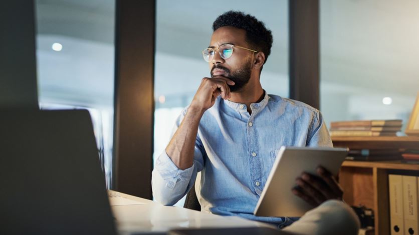 man holding tablet looking at screen