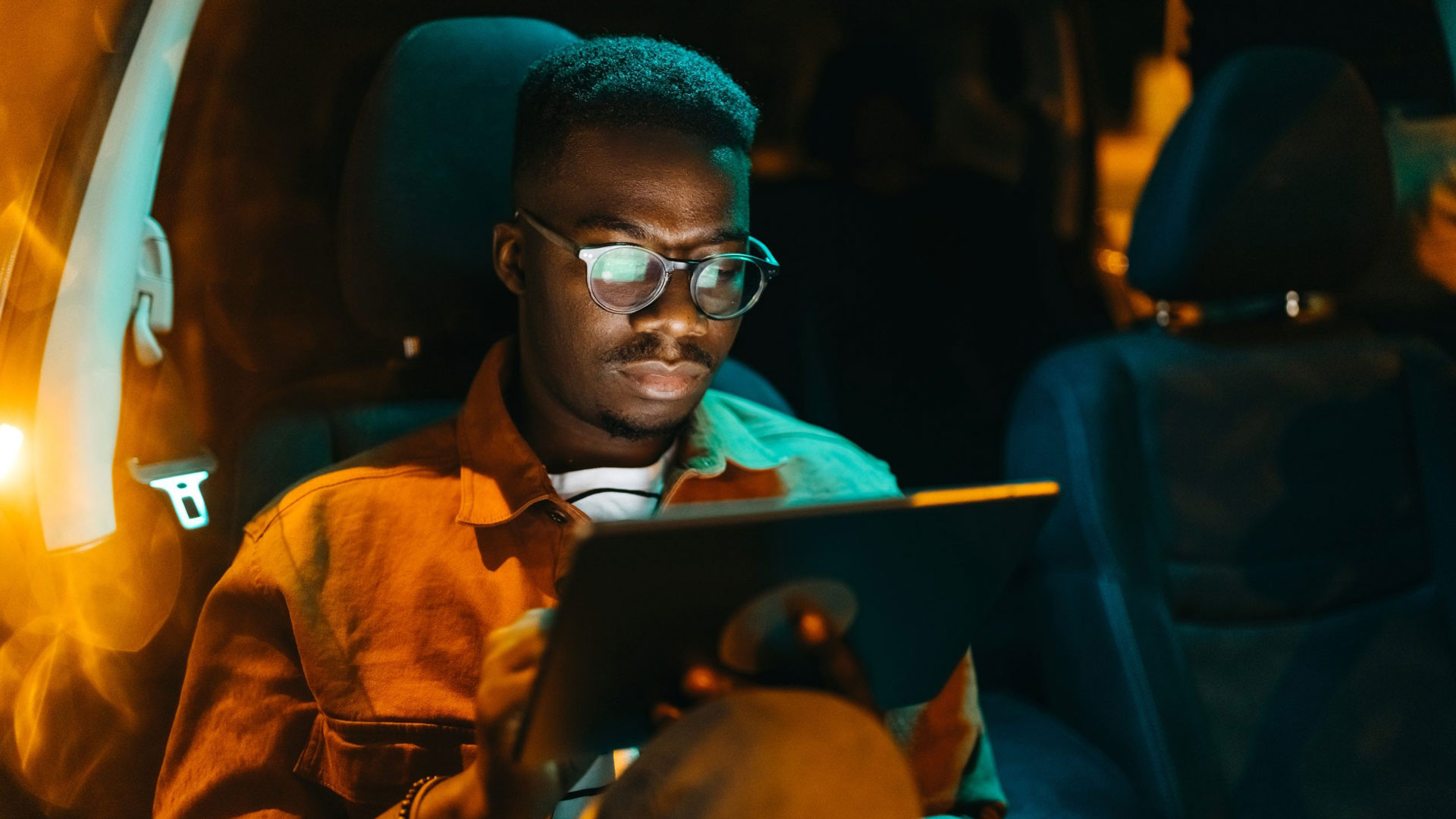 Man-looking-at-ipad-dark-image