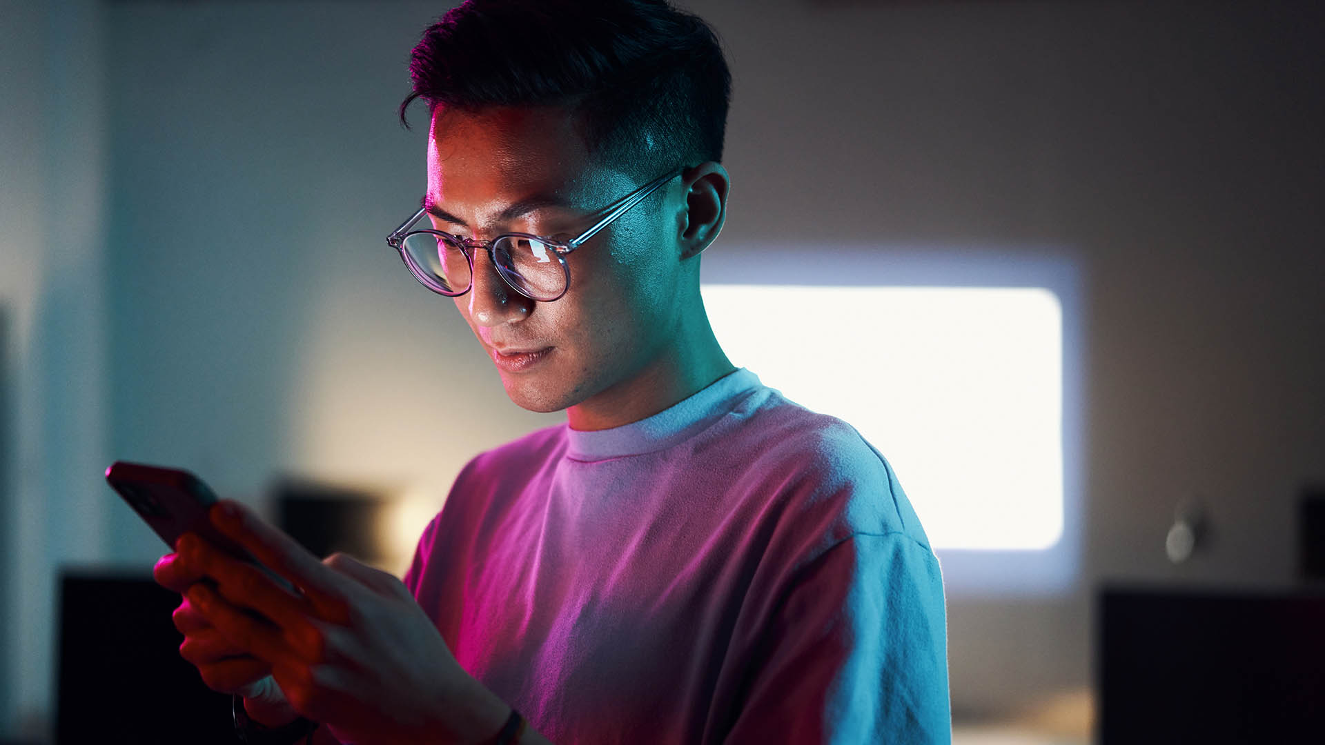 Man looking at phone at night