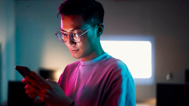 Man looking at phone at night