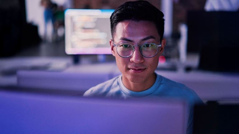 man looking at screen at nighttime