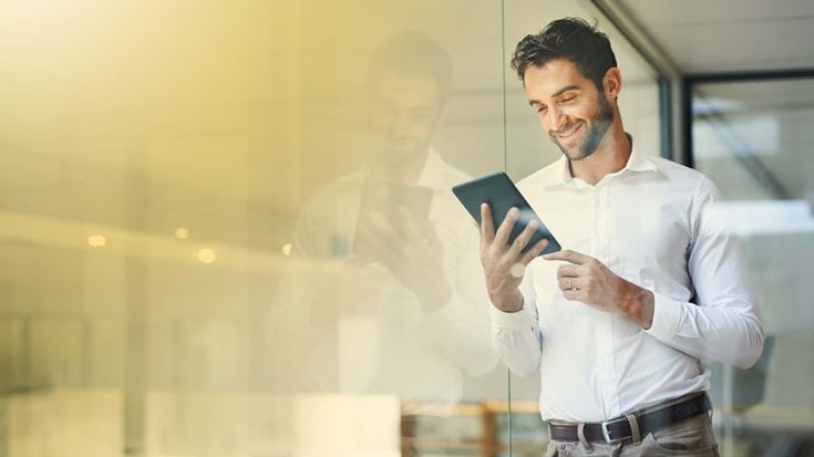 man looking at tablet