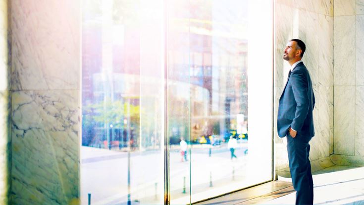 Man looking out of office window