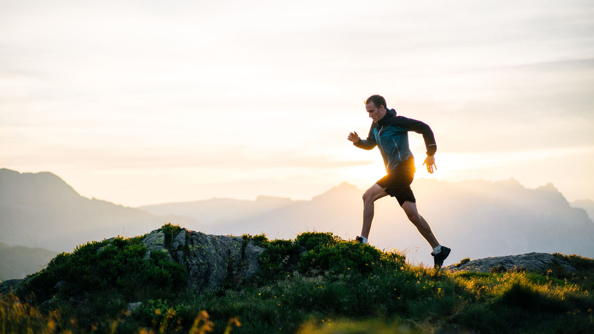 Man running on hilltop