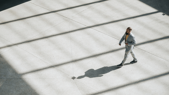 man-walking-across-open-area