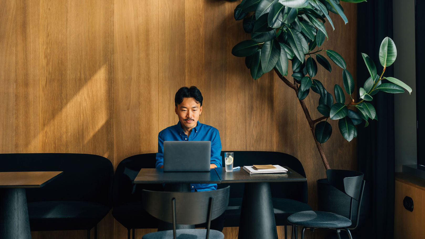 man working on laptop in a minimalist office