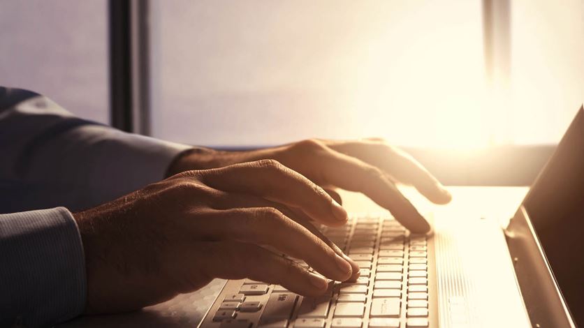 female-hand-on-laptop darker