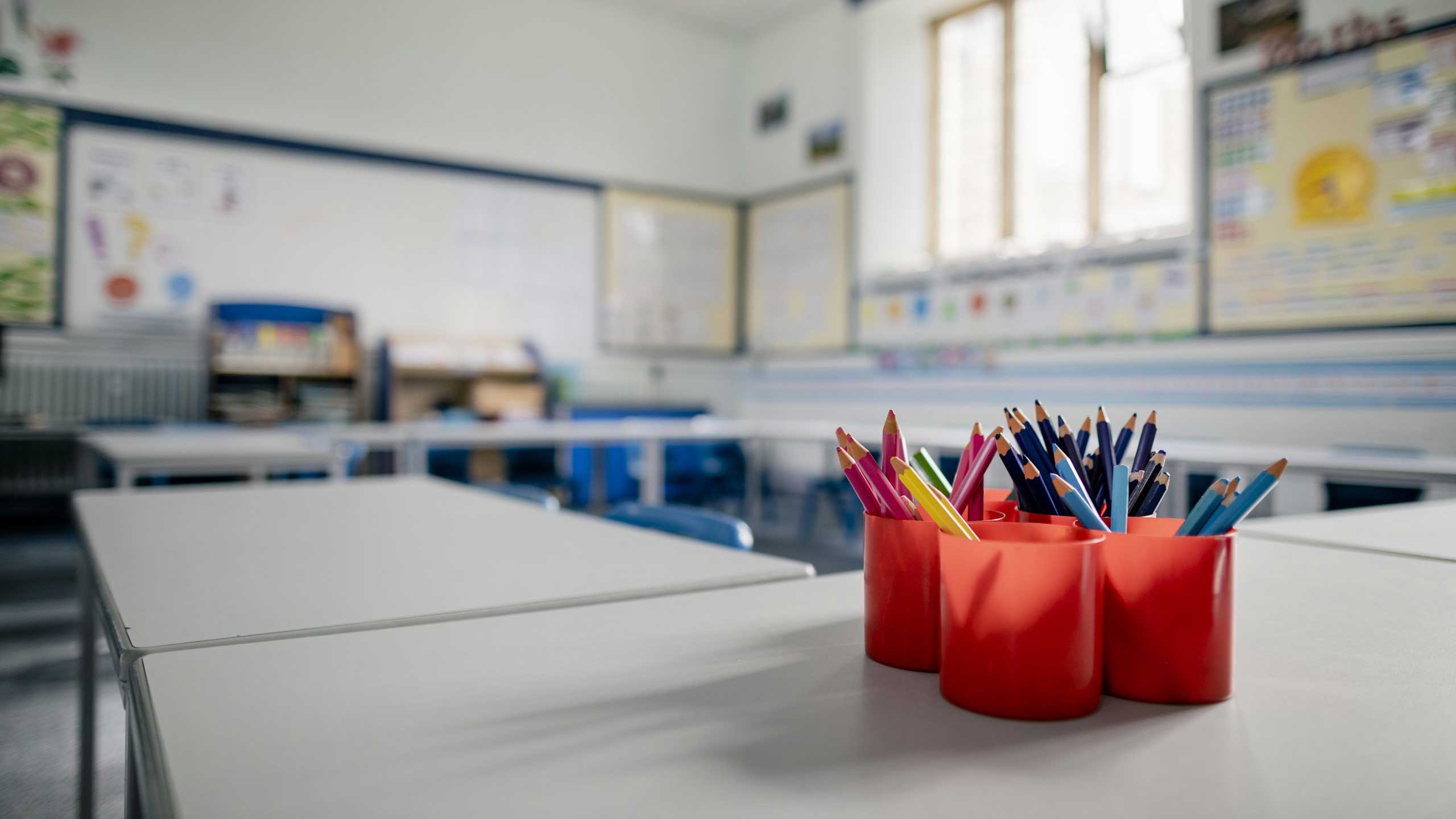 Close up of colouring pencils in an empty school classroom