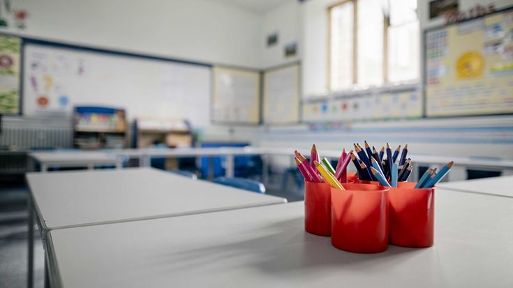 Close up of colouring pencils in an empty school classroom