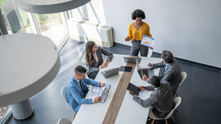 people analysing data in business meeting