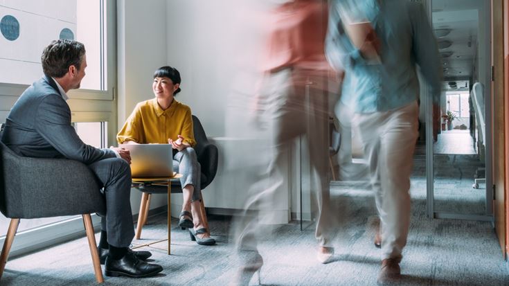 people having a meeting in corridor