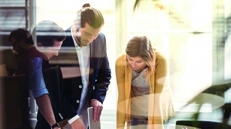 people-looking-down-at-desk