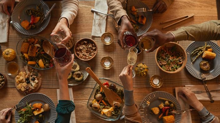 people sharing food and drink on a table