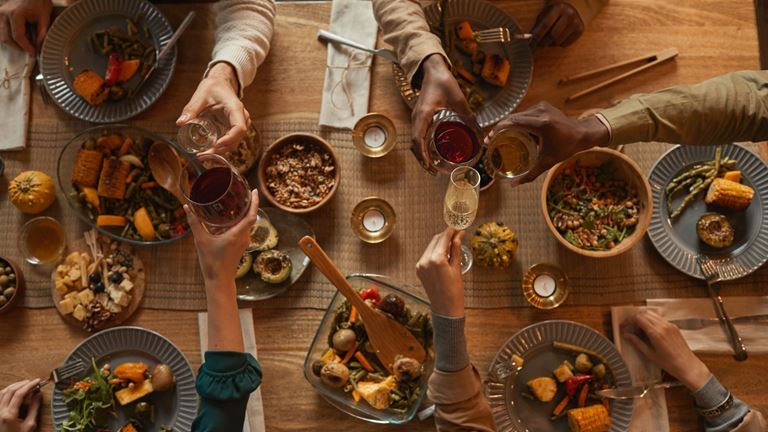 people sharing food and drink on a table