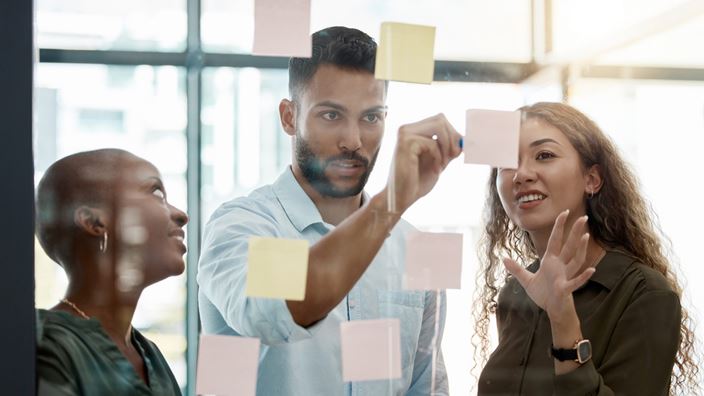 people with sticky notes on window