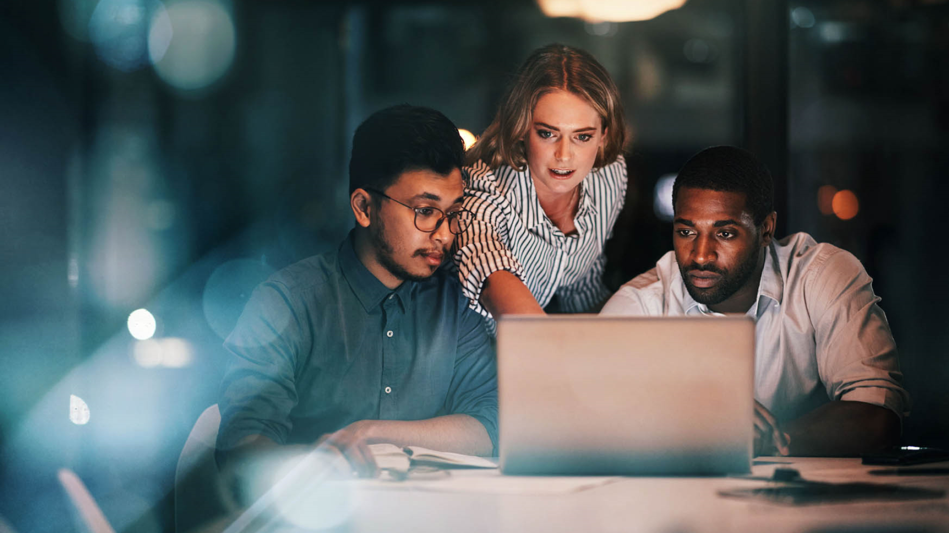 people working on laptop at night