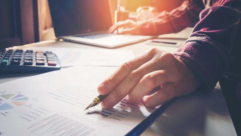 A hand writing on documents