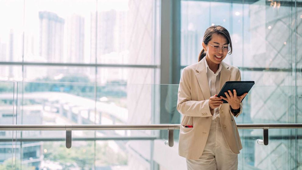 Professional woman smiling at a tablet