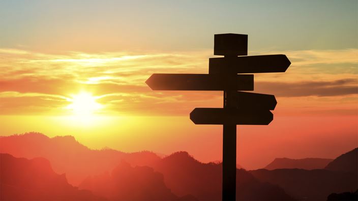 Signpost at sunset
