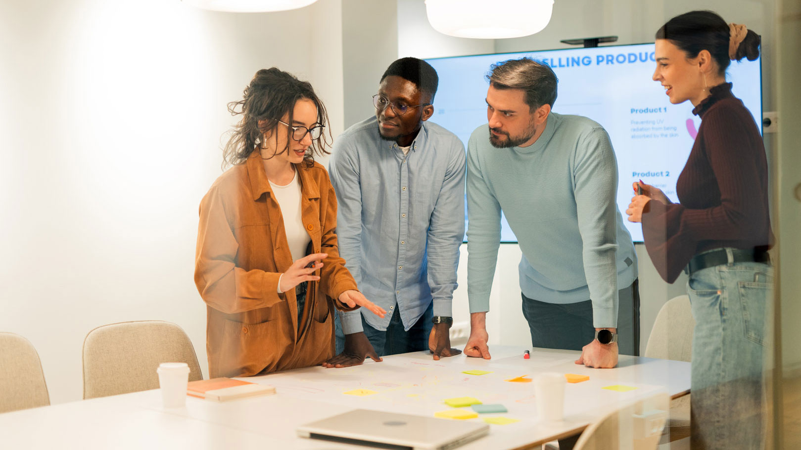 A team analyzing data and developing new product during a meeting
