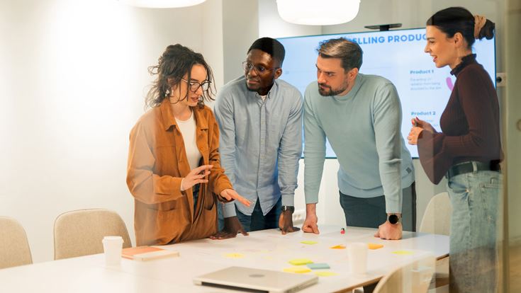 A team analyzing data and developing new product during a meeting